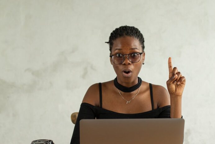excited black woman using laptop